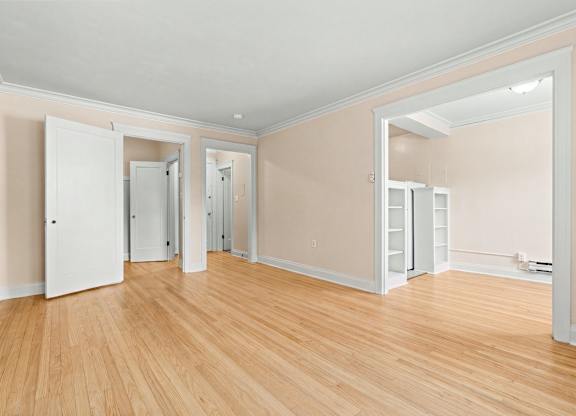 A room with wooden floors and white walls.