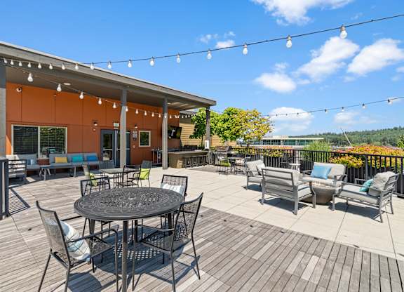A patio with a table and chairs is set up outside a building.