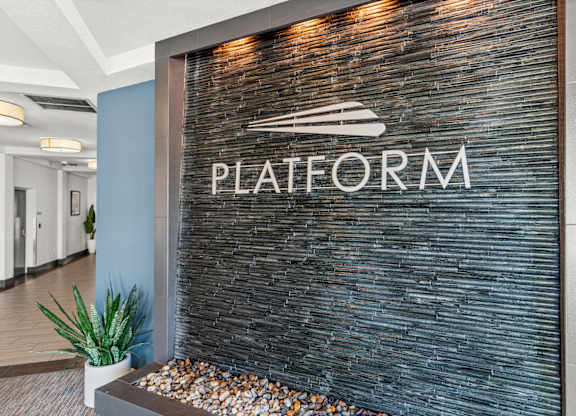 A sign that says Platform is on a wall.