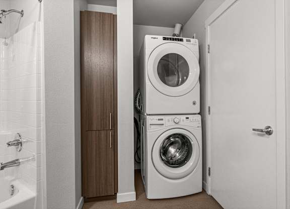 A white washing machine and dryer in a small laundry room.