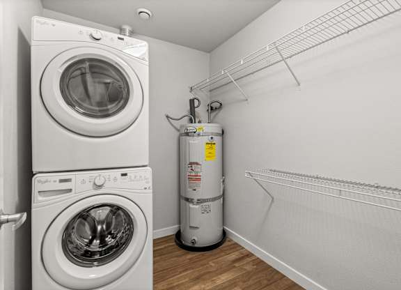 A white washing machine and dryer in a laundry room.
