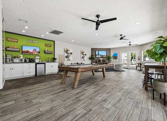A spacious kitchen and dining area with wooden flooring and modern appliances.