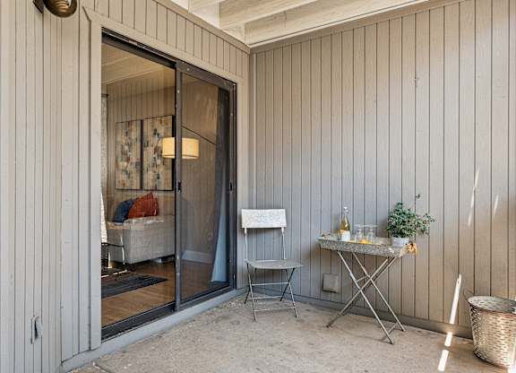 A patio with a table and chairs is shown.