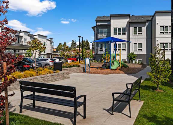 A park with a bench and a playground.