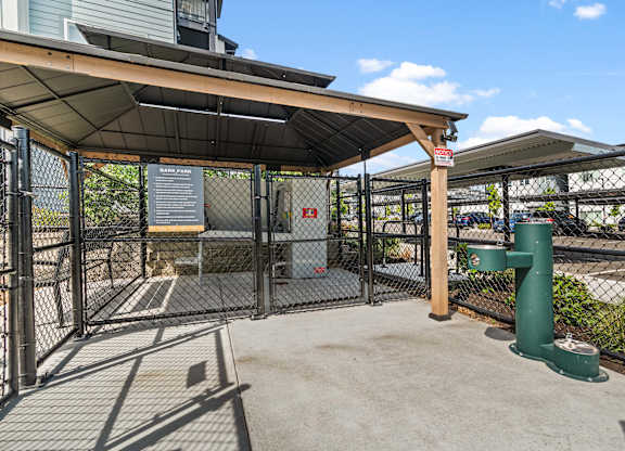 A green post stands in a concrete courtyard.