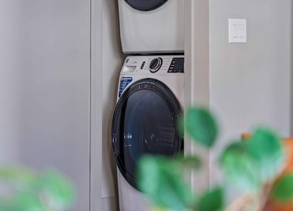 Two washing machines are stacked on top of each other.