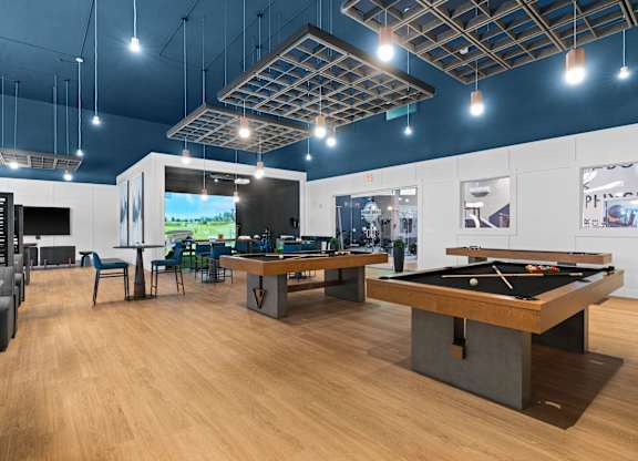 A room with a pool table and a ping pong table.