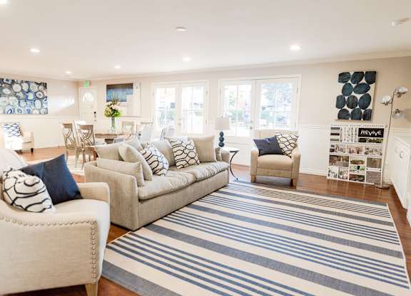 Living room with couch and interior design at ReVive Apartments, Fife, WA, 98424