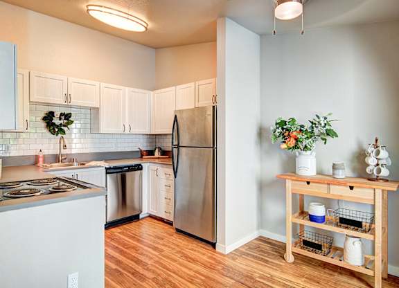 Everett Apartments=-  The Lynx Kitchen with White Cabinets at The Lynx Apartments, Everett, Washington