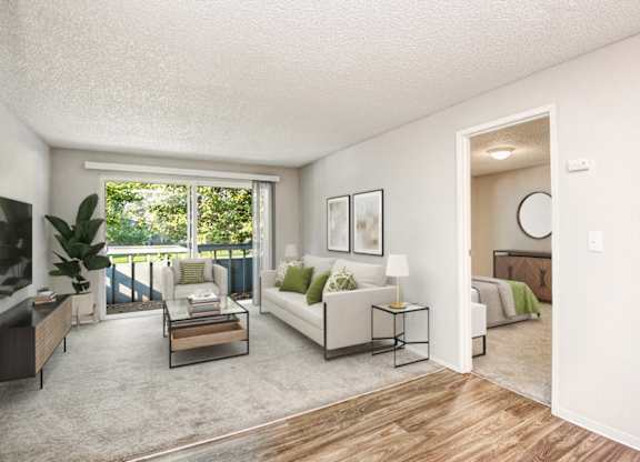 A living room with a white couch and a coffee table.