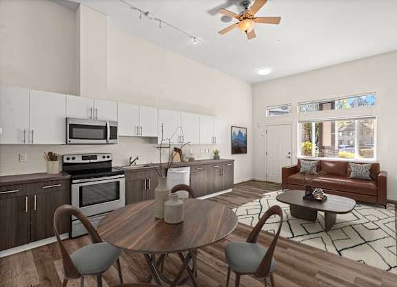 A modern kitchen with a wooden table and chairs.