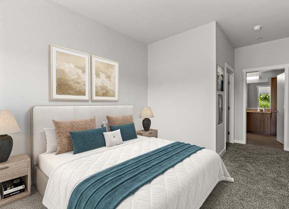 A bedroom with a large bed and two framed pictures on the wall.
