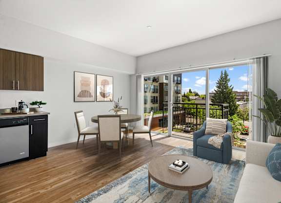 A modern living room with a dining area and a kitchen in the background.