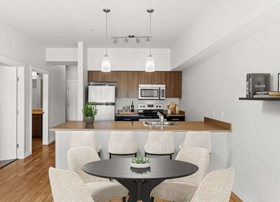 A modern kitchen with a dining table and chairs.