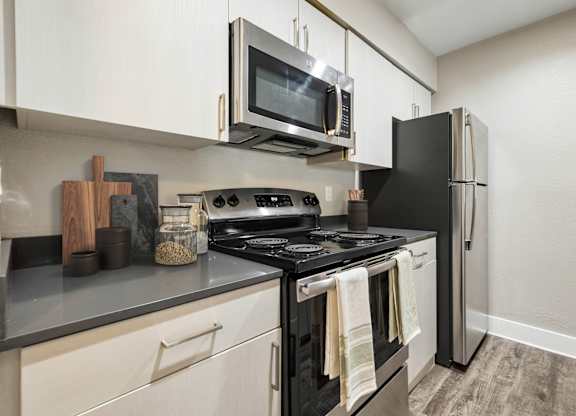 A black stove top oven with a towel hanging on it.