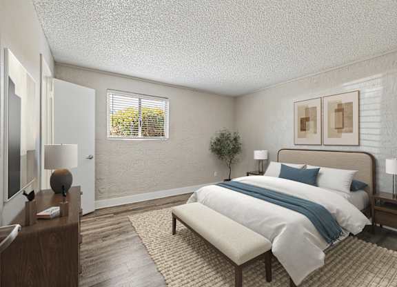 A bedroom with a bed, nightstand, and window.