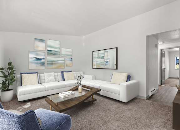 A living room with a white couch, a blue chair, and a painting on the wall.