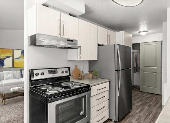 A modern kitchen with a black stove and a black refrigerator.