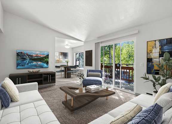 A modern living room with a large painting on the wall and a view of the outdoors through the sliding glass doors.