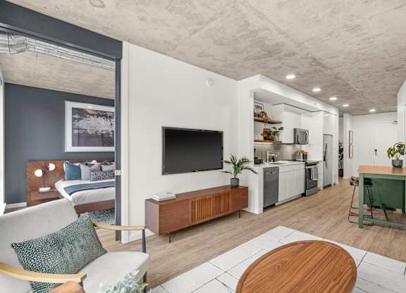 A modern living room with a white couch and a wooden coffee table.