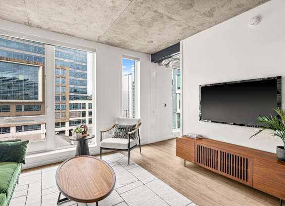 A living room with a flat screen TV mounted on the wall.