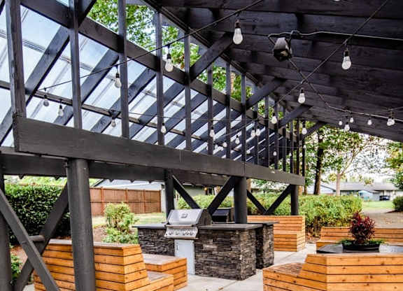 A wooden structure with a glass roof and hanging lights. at The Retreat, Sumner, Washington