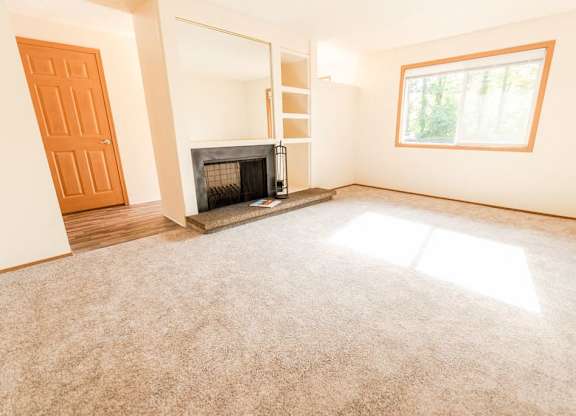 A room with a fireplace and a window. at The Retreat, Sumner, WA, 98390