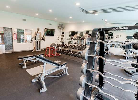 A gym with a variety of equipment including a squat rack and a bench press. at Notch 8, Tacoma, WA, 98444