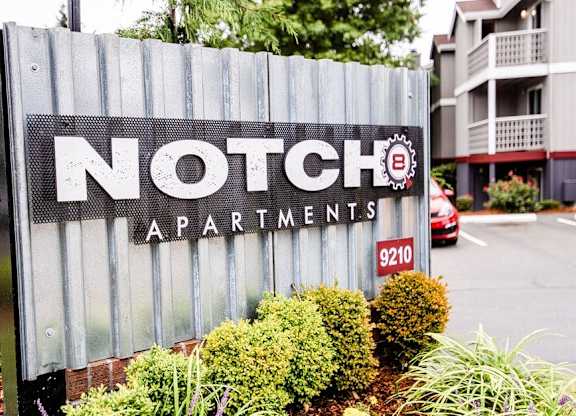 A sign for Notch Apartments is in front of a building. at Notch 8, Tacoma, Washington