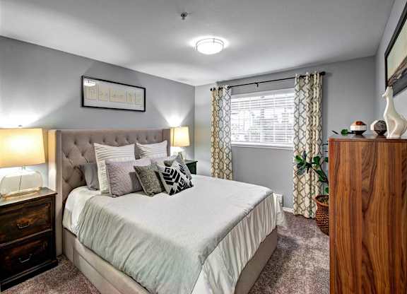 Bedroom with bed and lamp at Deer Creek Apartments, Puyallup, 98373
