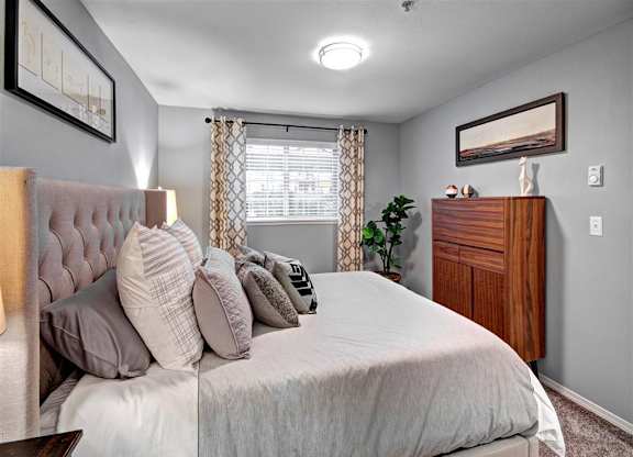 Puyallup Apartments- Deer Creek Apartments- bedroom with cozy bed at Deer Creek Apartments, Washington