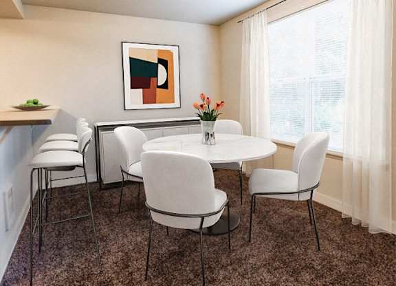 A dining room with a white table and chairs.