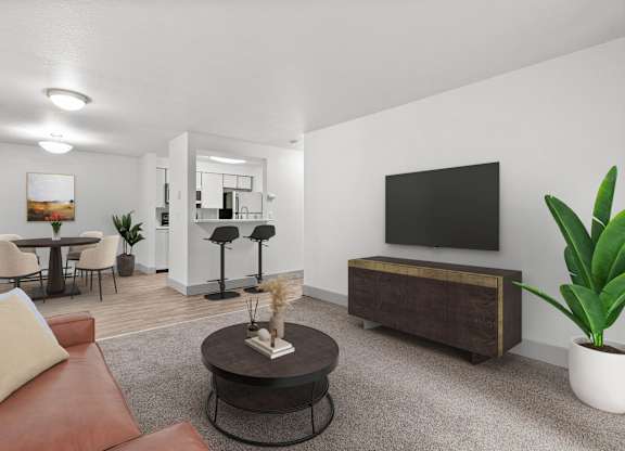 A living room with a brown leather couch, a coffee table, a television, and a potted plant.