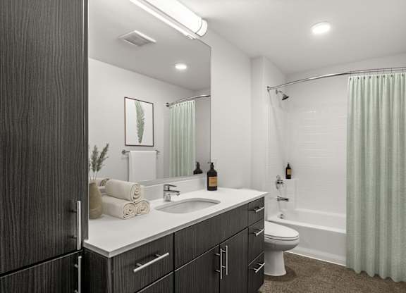 A bathroom with a sink, toilet, and bathtub.