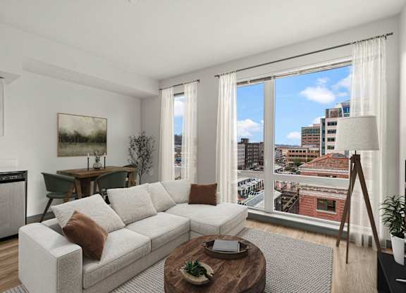 A living room with a large window overlooking a cityscape.