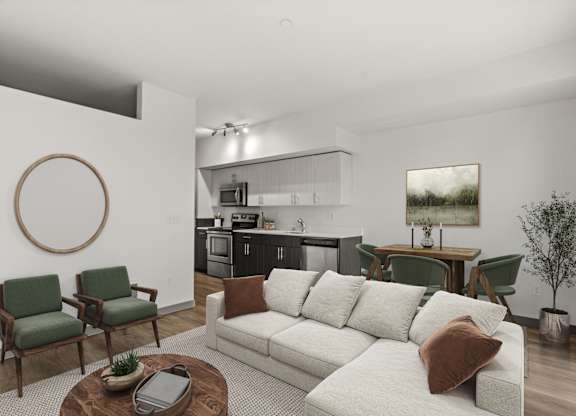 A living room with a white couch and green chairs.