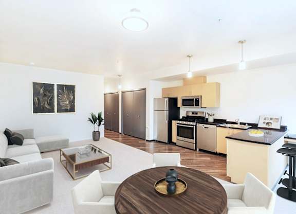 A modern open plan living and kitchen area with a dining table and chairs.