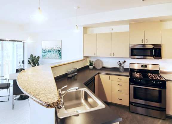 A modern kitchen with a stainless steel sink and a large island.