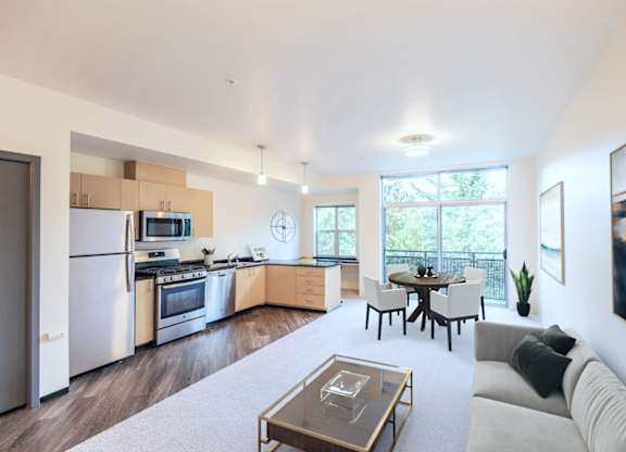A modern kitchen with a dining table and chairs.