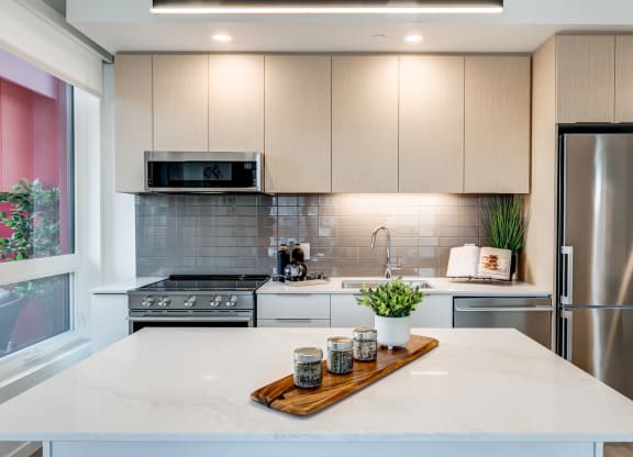Suite Interiors-Stylish Finishes Including Quartz Countertops, Sleek Soft-Close Cabinetry and Porcelain Tile Backsplash at Southpark, Edmonton, Alberta