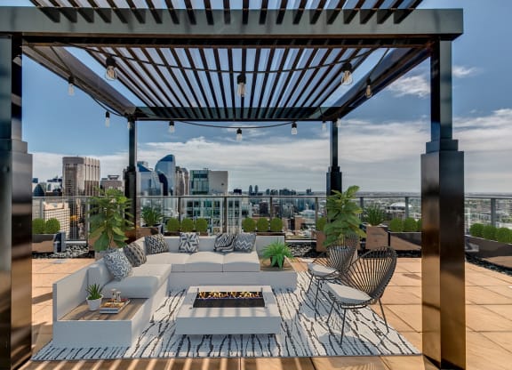 a roof terrace with furniture and a view of the city at Versus Apartments, Alberta