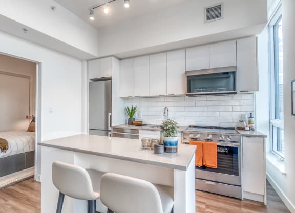 Fitted Kitchen With Island Dining at BLVD Beltline, Calgary, AB