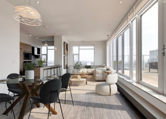 a living room and dining room with large windows and a table and chairs  at Versus Apartments, Calgary, AB, T2R 1A8
