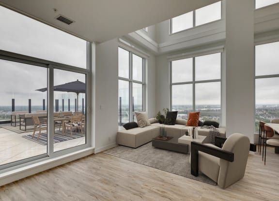 a living room with large windows and a couch and a table at BLVD Beltline, Calgary, AB
