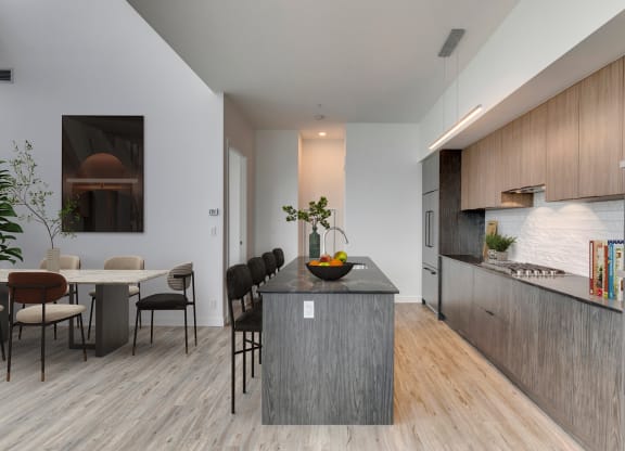 a kitchen with a large island and a dining table at BLVD Beltline, Calgary, AB