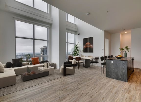 a living room with a large window and a table with chairs at BLVD Beltline, Calgary, AB