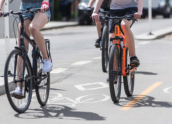 Riding bikes and bicycles on Whyte Avenue Old Strathcona at Southpark, Edmonton, Alberta