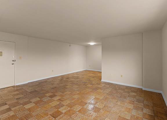 A empty room with wooden flooring at Kensington House, Kensington, 20895
