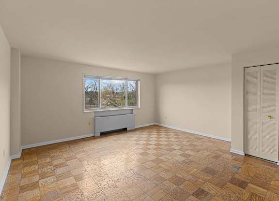 A room with a brown tiled floor and a window at Kensington House, Kensington, Maryland