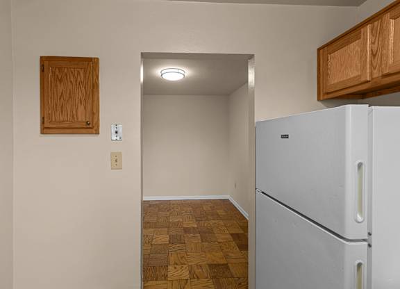 A kitchen with a white fridge at Kensington House, Kensington